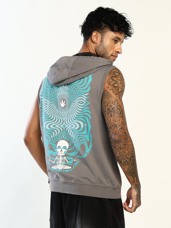 A man wearing a sleeveless gray hoodie with a large turquoise and white back graphic featuring a meditating skull and psychedelic swirls, shown from the back against a plain light background.