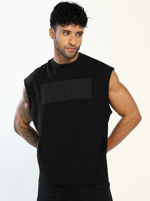 A man wearing a black sleeveless muscle t-shirt with a tonal black graphic text 'PUNK' across the chest, posed against a light off-white background.